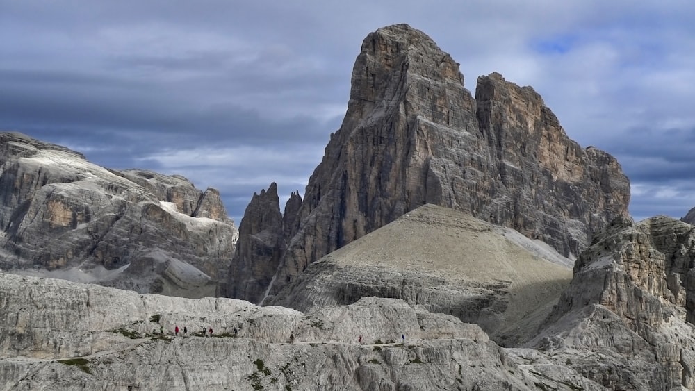 rocky cliff under cloudy sky