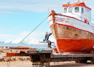 Fiberglass repair work in progress on a mid-sized sailing boat in the workshop.
