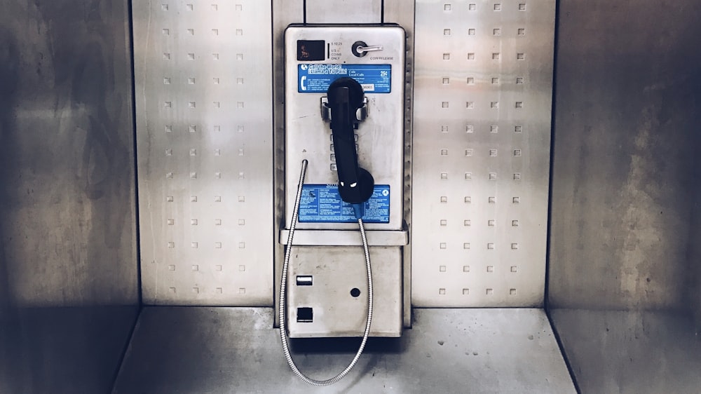gray payphone close up photography