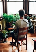 A patient receiving a consultation surrounded by natural plants.