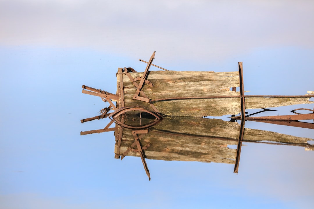 brown wooden ship wheel under blue sky during daytime