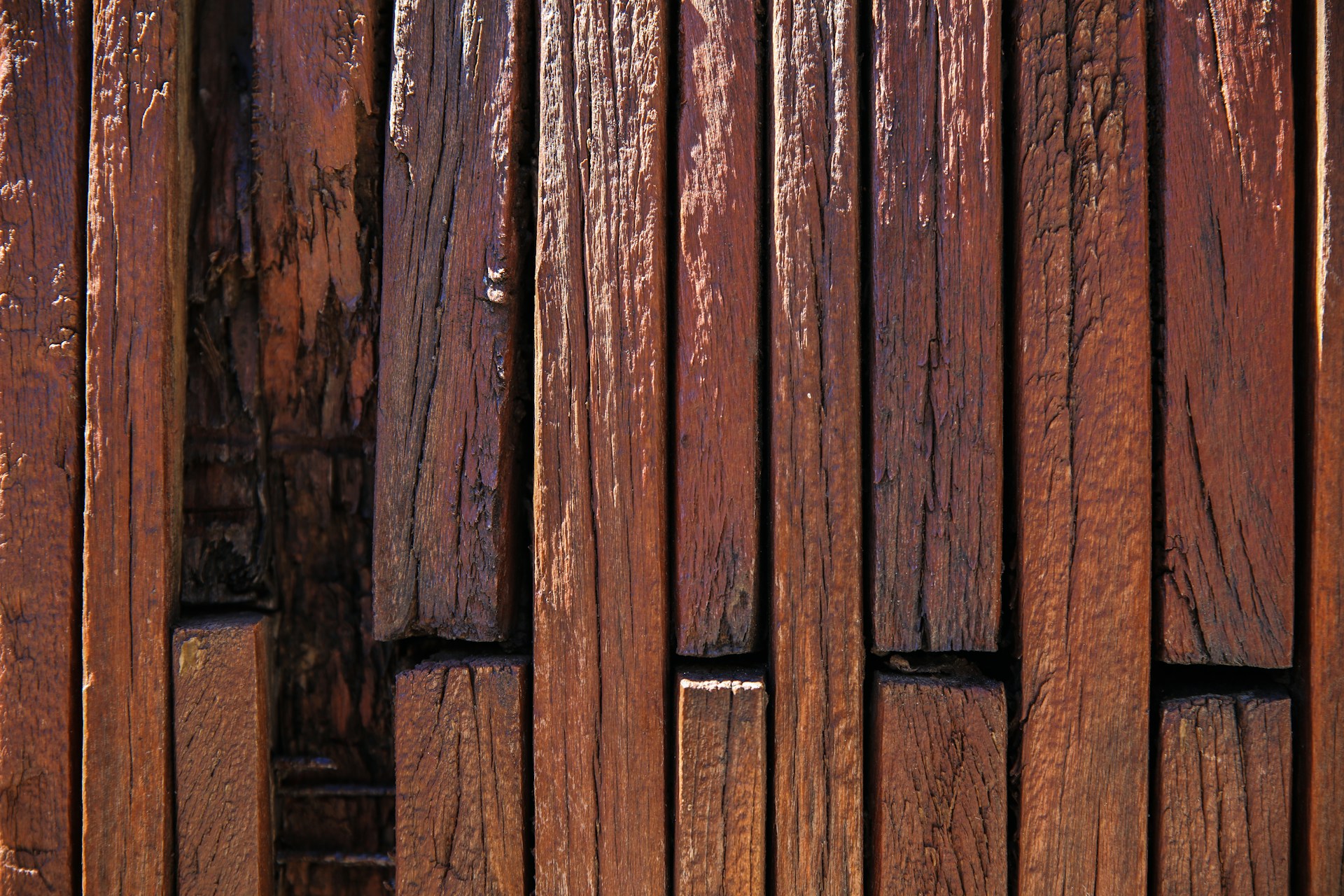 brown wooden board with black metal fence