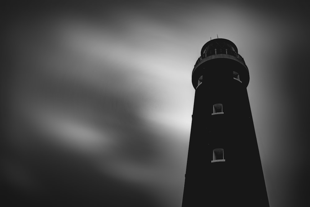 low angle photography of black lighthouse