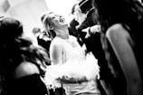 A photographer capturing joyful moments at a gathering.