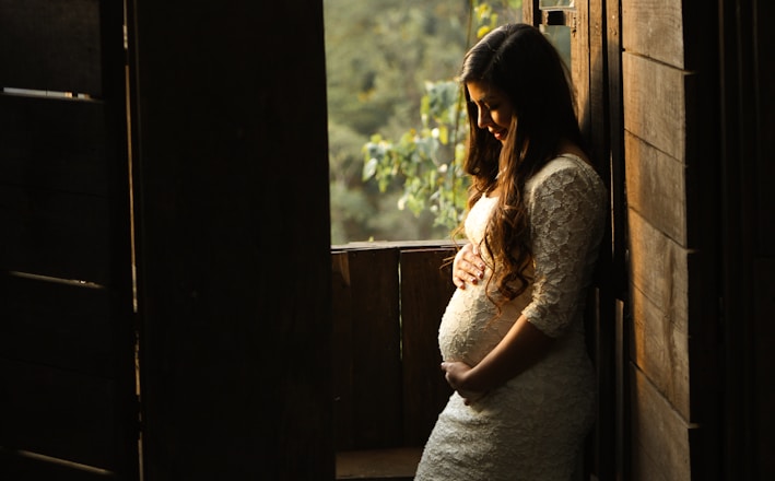 pregnant woman holding her womb