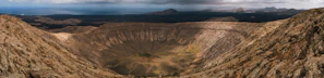 A panoramic view of Ngorongoro Crater with wildlife scattered across the valley floor