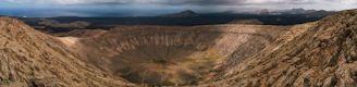 A panoramic view of Ngorongoro Crater with wildlife scattered across the valley floor