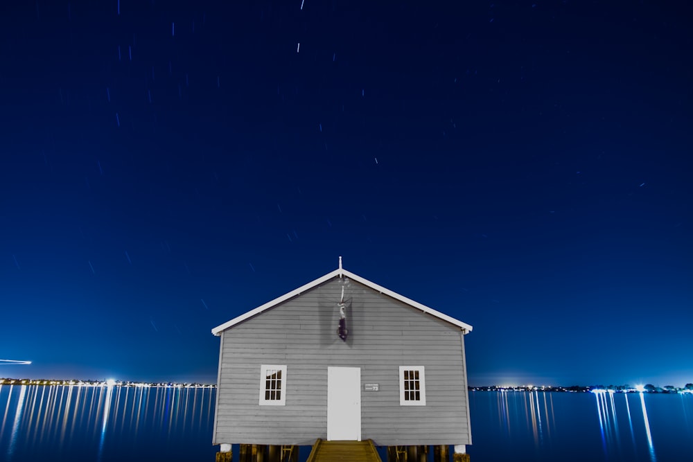 gray house surrounded with body of water photo