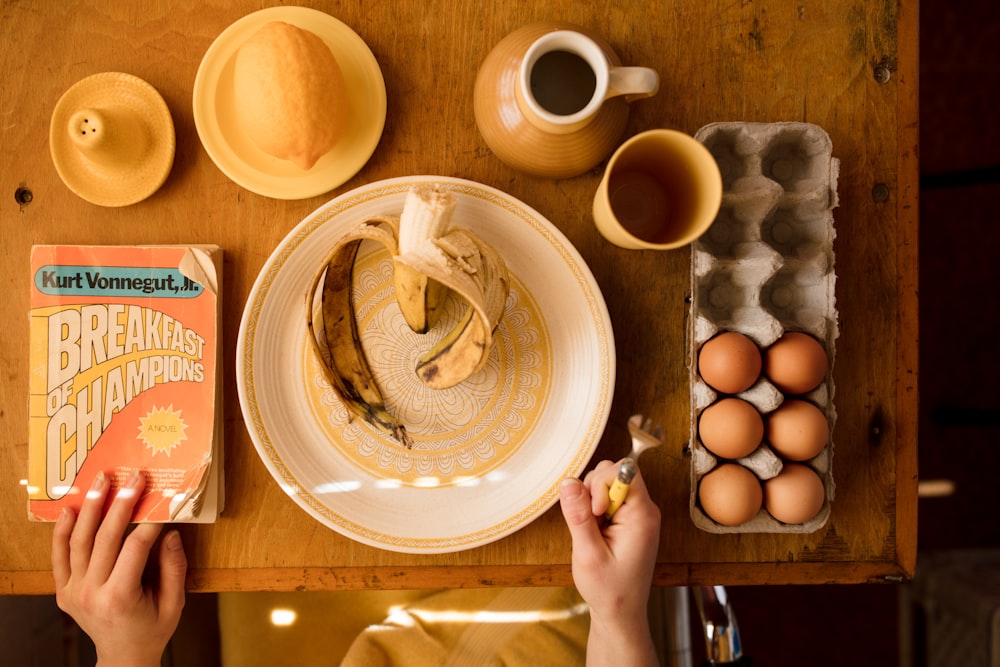 plate with banana and tray of eggs on table