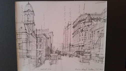 A detailed black and white sketch of an old city street.