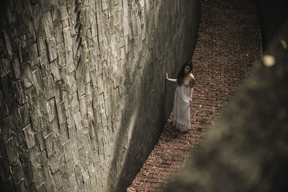 donna in piedi accanto al muro