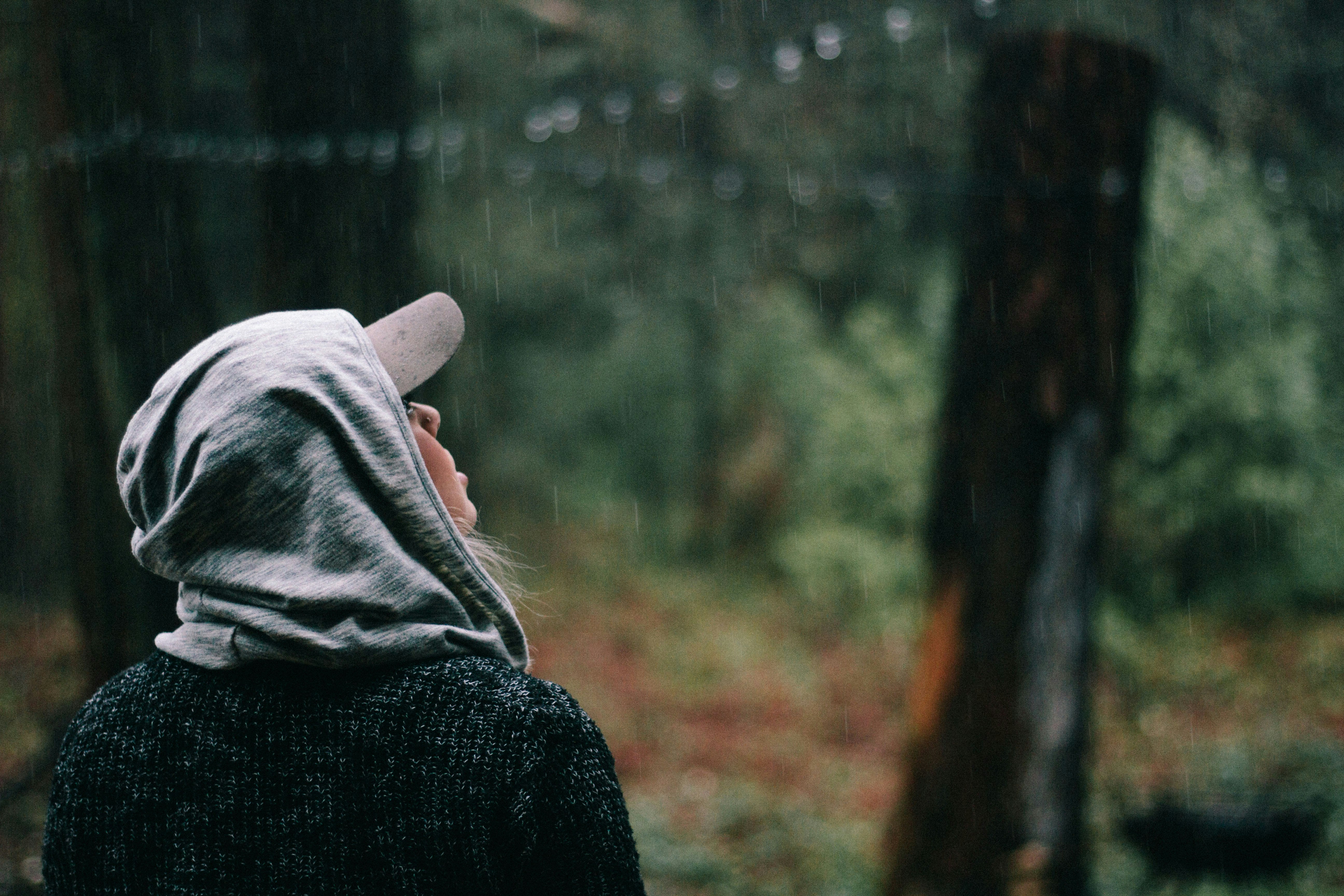 person looking at the rain drops