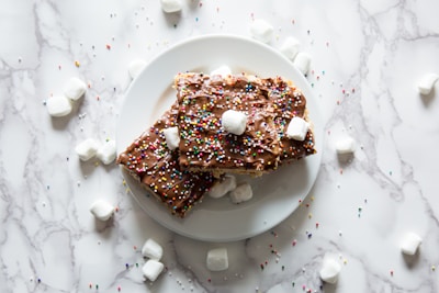 Homemade brigadeiros decorated with chocolate sprinkles on a festive plate