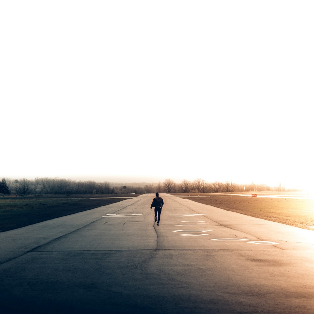 man walking on road