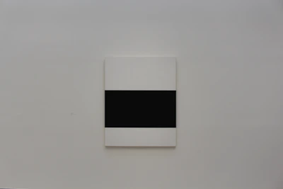 Square canvas artwork displayed on a white wall, highlighting the 1:1 proportion.