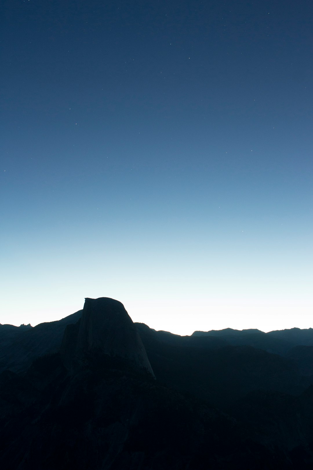 silhouette of mountain under blue sky during daytime