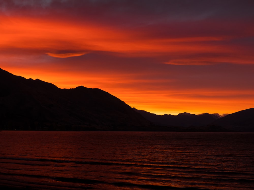 body of water under sunset