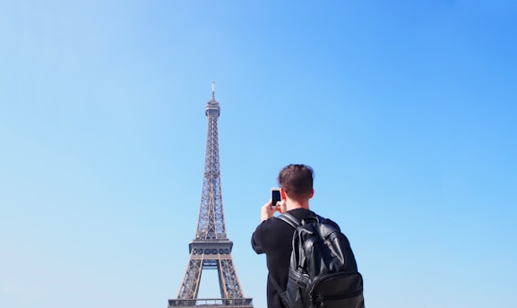 A traveler with a backpack admiring a famous international landmark.