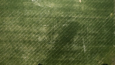 an aerial view of a green field with a bird's eye view of a