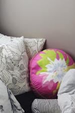 A selection of colorful pillows arranged invitingly on a sunlit sofa.
