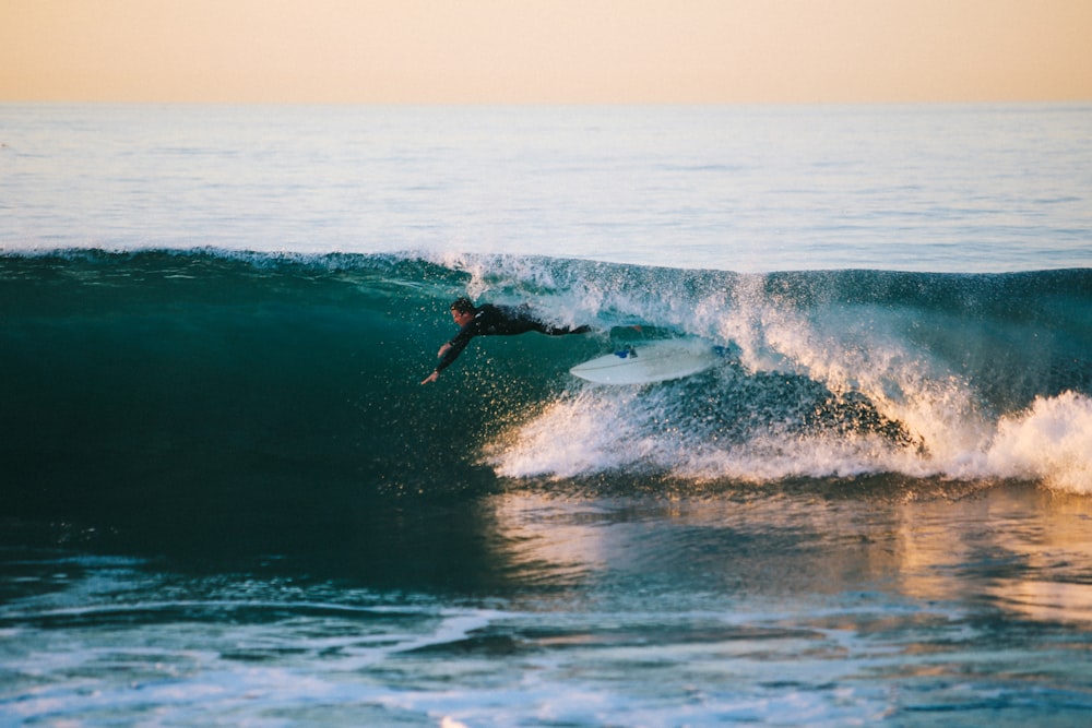 man surfing under wave