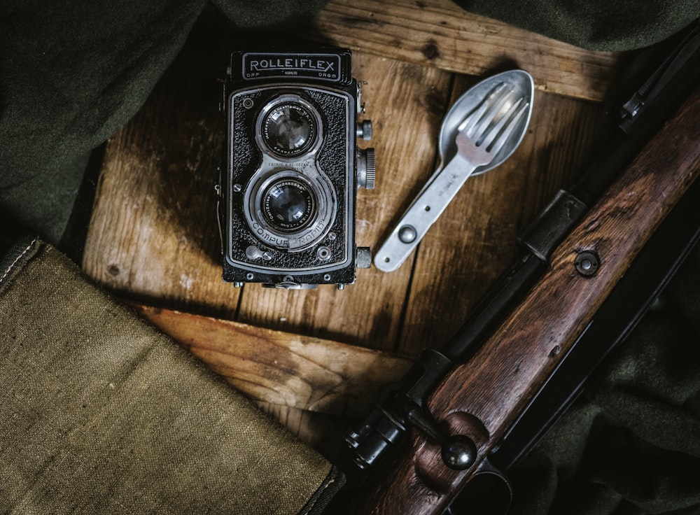 black land camera beside spoon and fork