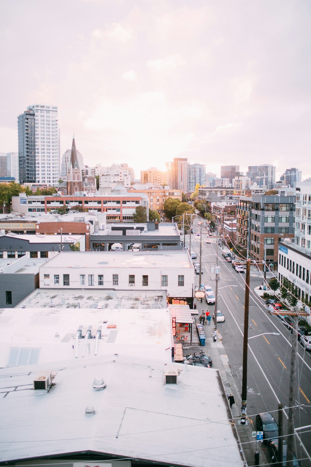 Rooftop shot of Capitol Hill road with city buildings and skyscrapers in background