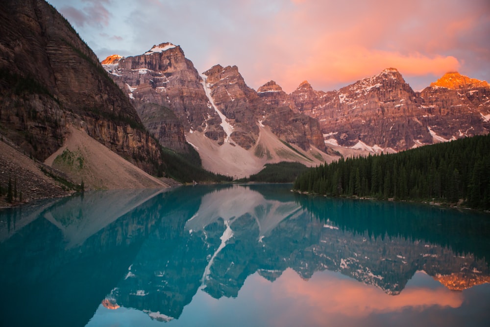 The azure Moraine Lake reflecting nearby mountains during sunset