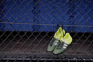 Atlético Nacional jersey hanging next to a pair of green sneakers and a soccer ball