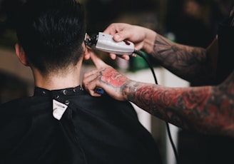 person using white hair clipper