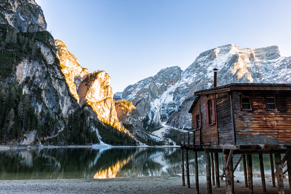 brown cabin beside lake