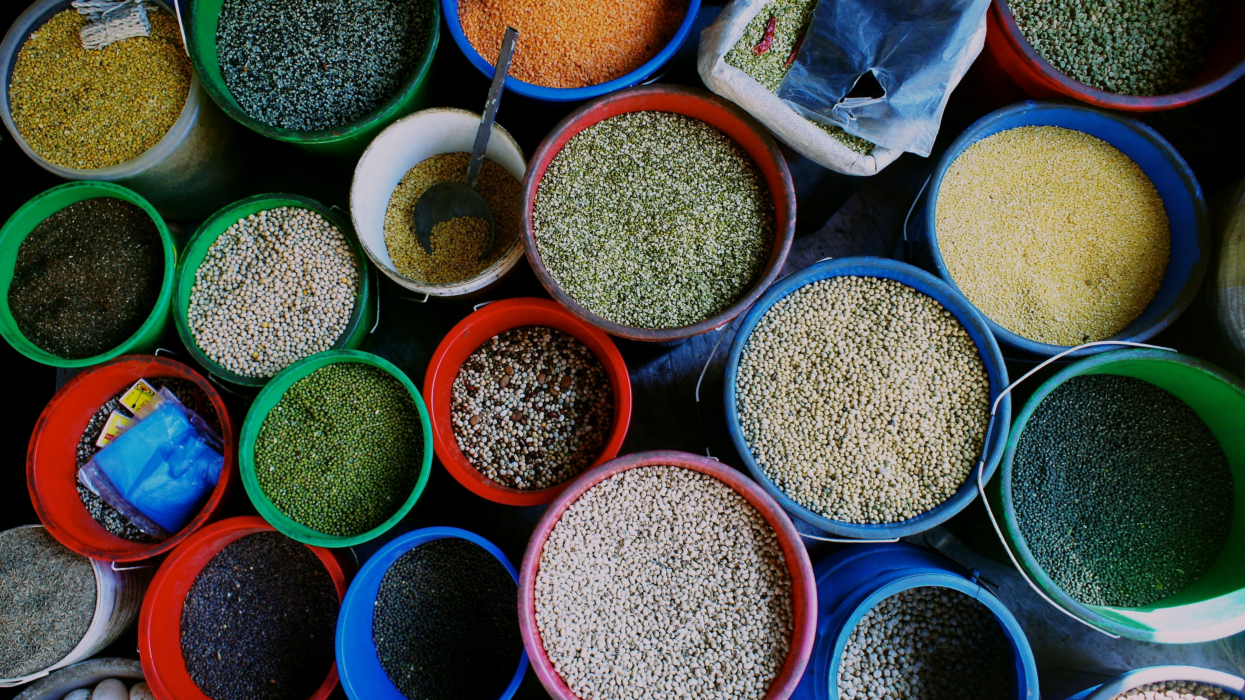 A vibrant display of assorted legumes in bulk bins.