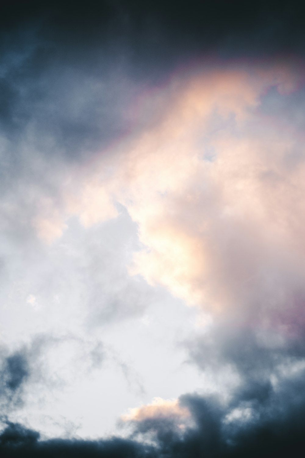 a plane flying through a cloudy sky