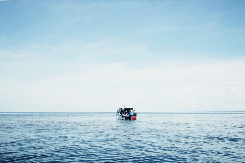 white and orange pontoon boat