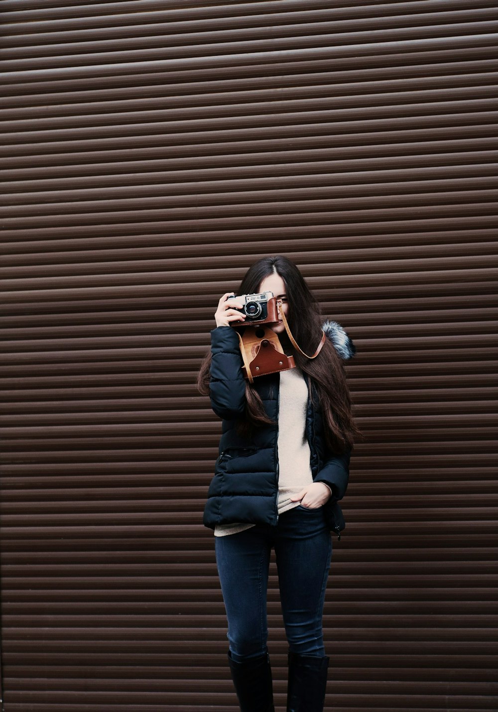 woman standing holding camera taking photo