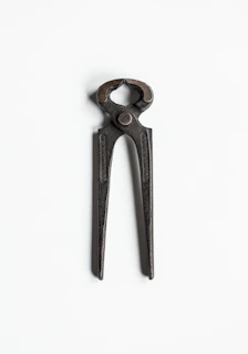 Gripora pliers with multiple tool functions extended, displayed against a clean white background