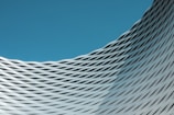 a building with wavy lines on it against a blue sky