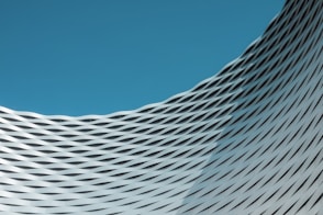 a building with wavy lines on it against a blue sky