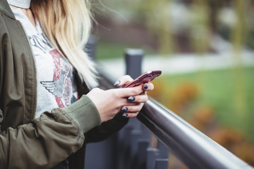 woman holding red phone