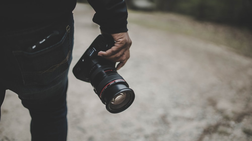 person holding DSLR camera