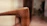 Close-up of finely detailed wood grain on a restored antique chair.
