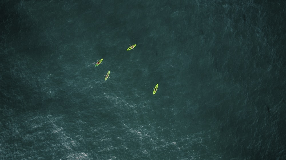 aerial photography of four green kayaks