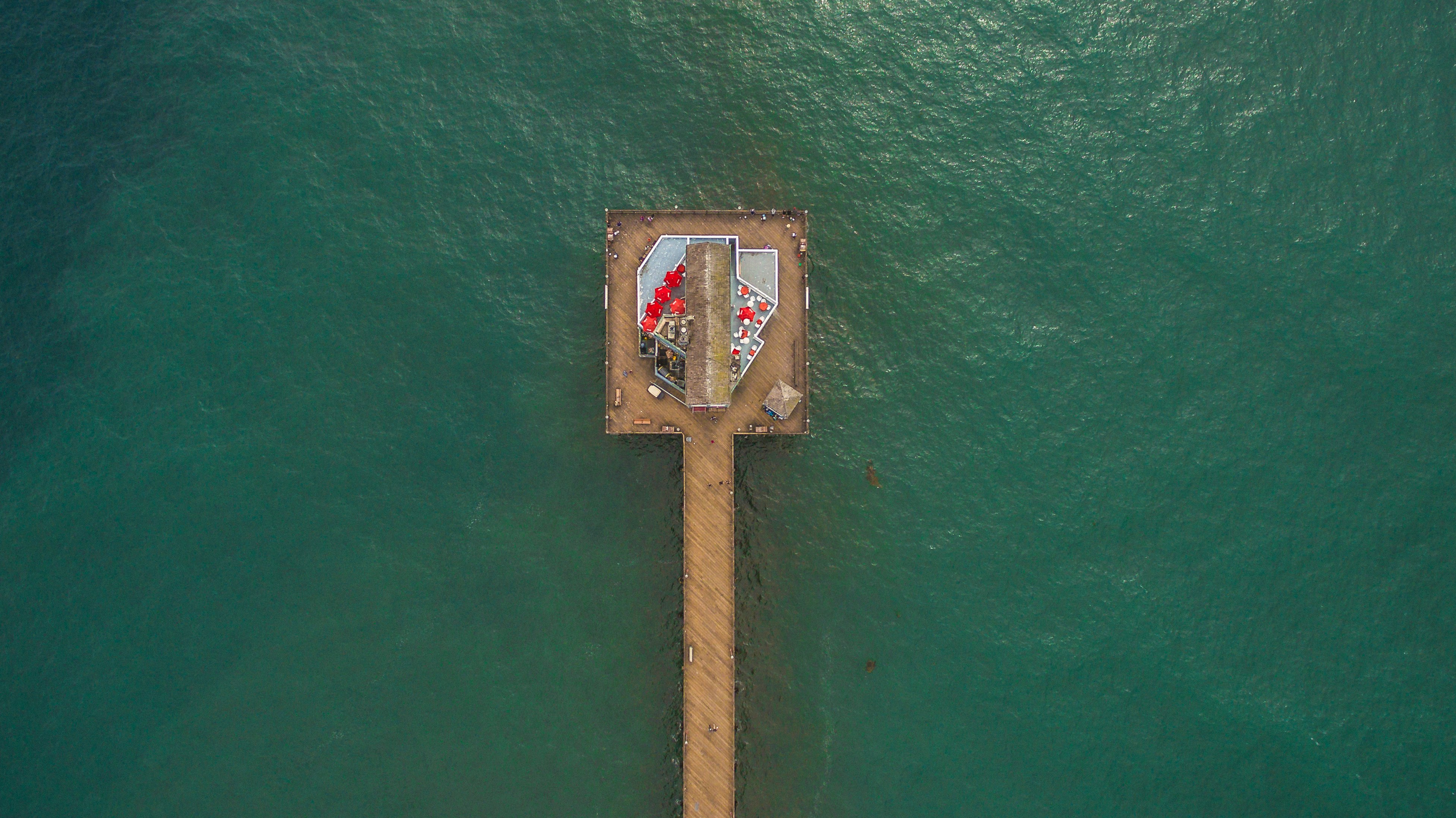 aerial shot photo of brown dock surrounded with body of water
