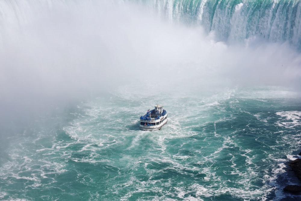 ship on body of water near falls