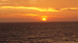 A vibrant sunset casting colorful hues over a peaceful ocean.
