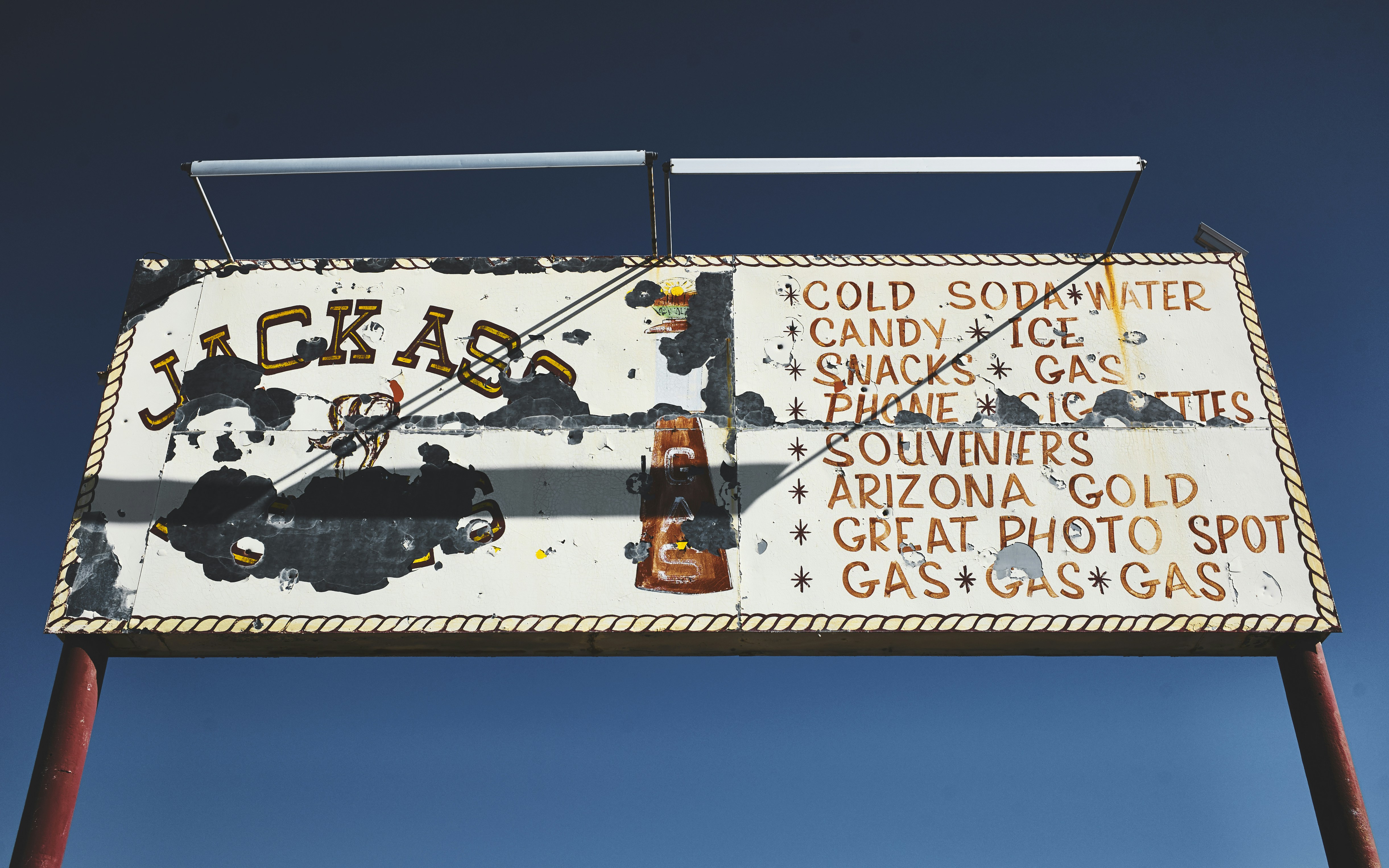 Jackass signboard on road.
