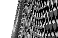 Custom metal façade with intricate geometric patterns catching the light.