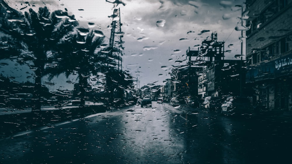 grayscale photo of buildings under cloudy skies