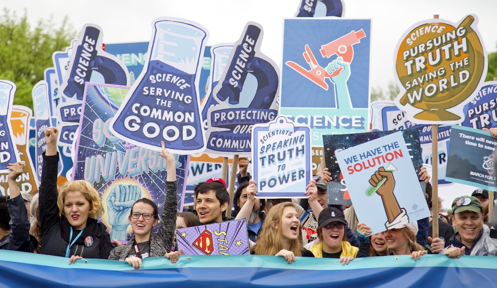 group of people with signages