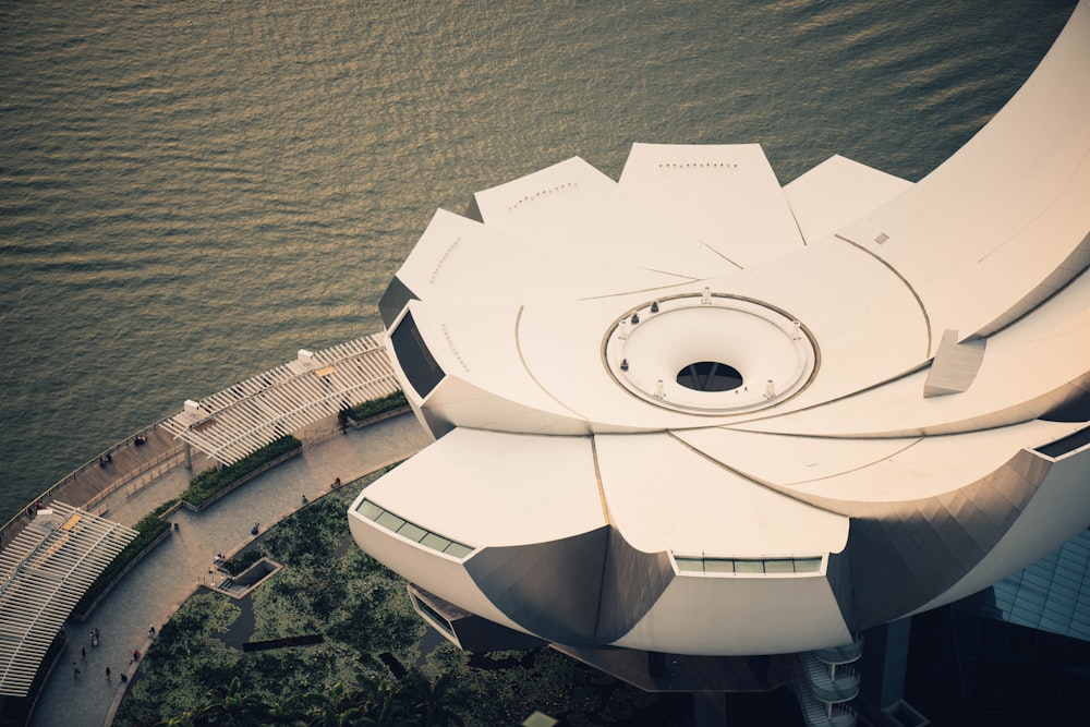 white and gray building near body of water in aerial photographty